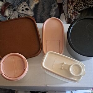 Tupperware set with brown, pink, cream, and black lids